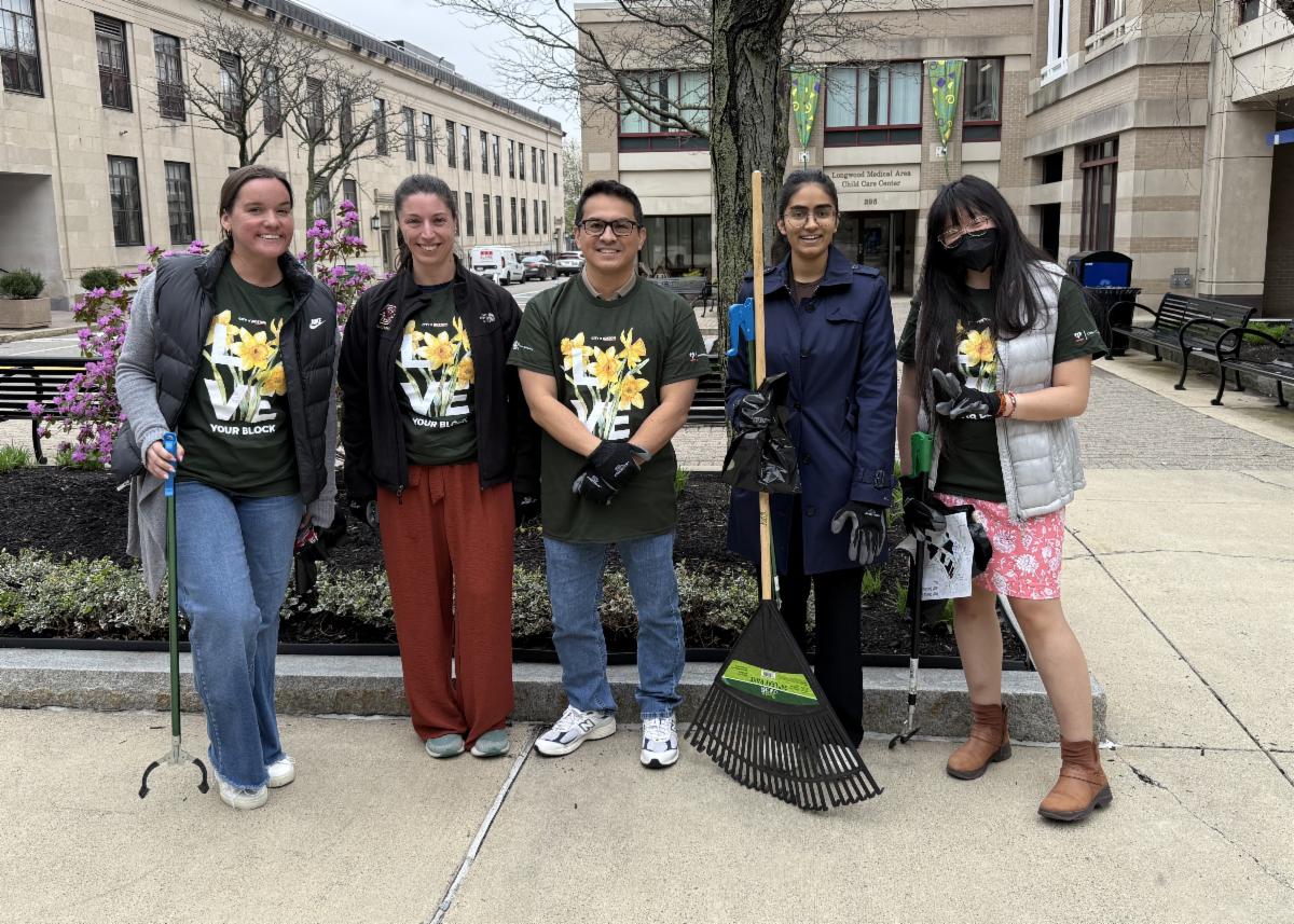 five staff members pose with clean up materials