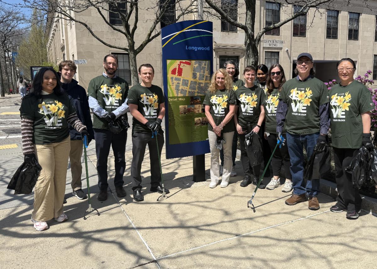 big group of staff pose in Love Your Block t shirts