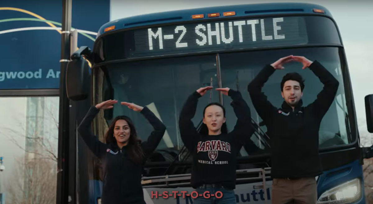 students create Os with their arms in front of M2 shuttle