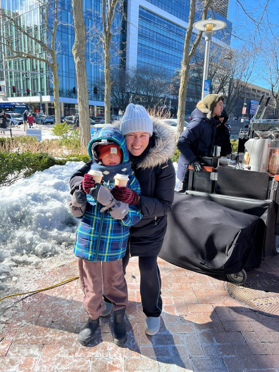 patient and mom pose with hot chocolate