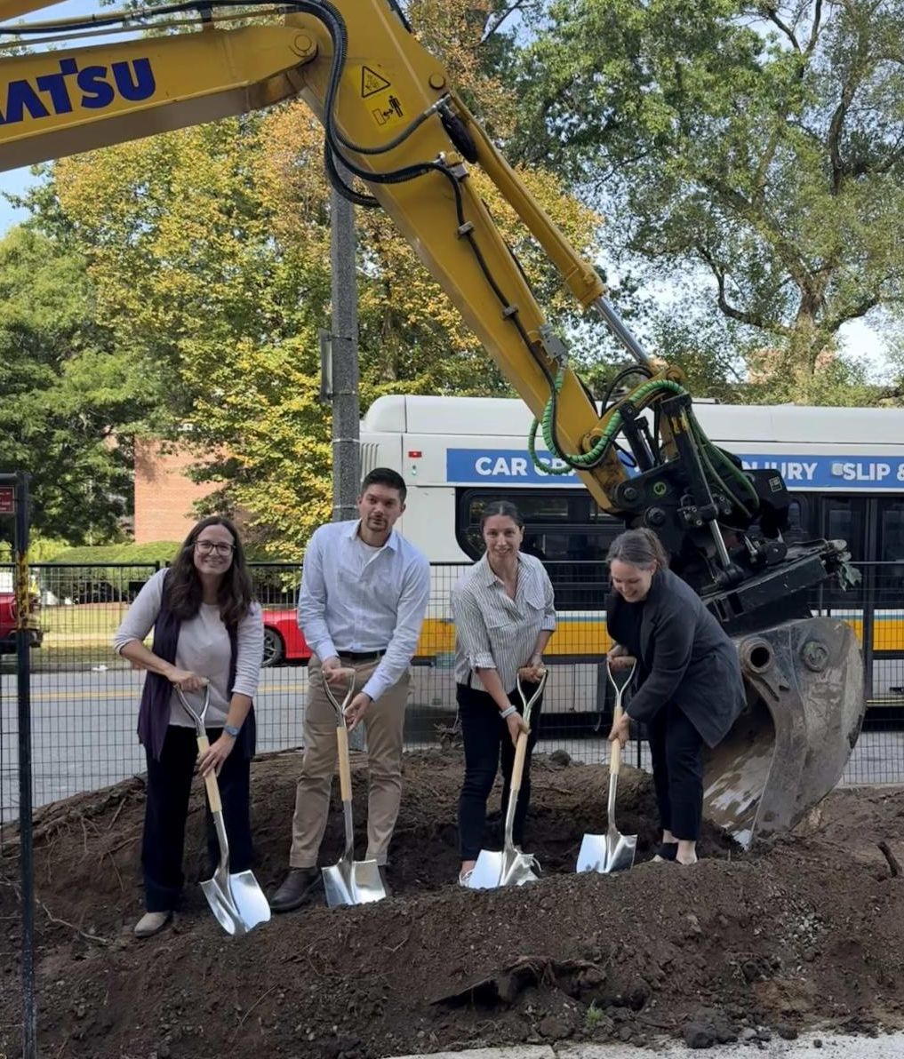 four people break ground with shovels
